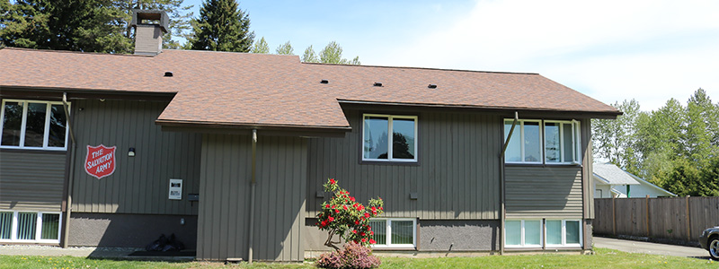 Exterior view of the Pidcock Shelter building with the Salvation Army shield sign on the front.